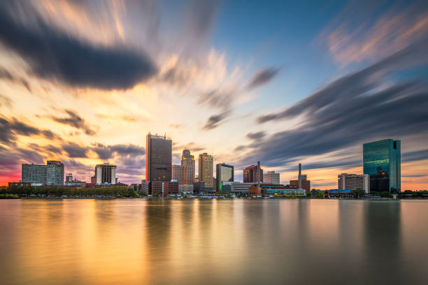 Toledo, Ohio, USA downtown skyline on the Maumee River at dusk.