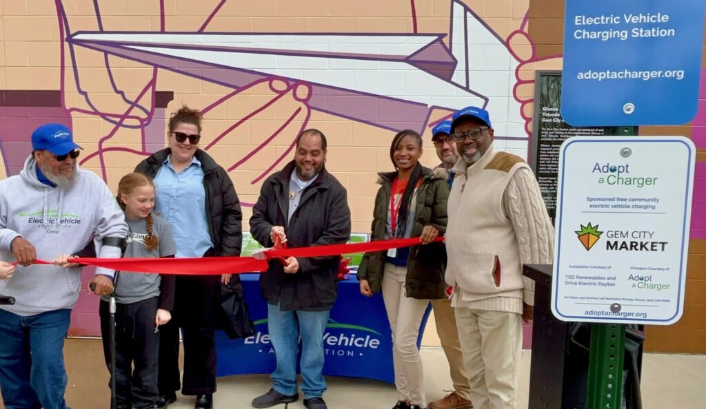Solclusion Energy Group and EVA of Ohio celebrate the opening of an EV charging station at the Gem City Market in Dayton.